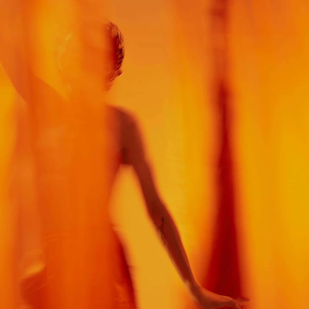 Abstract human form in warm orange hues symbolizing transformation.